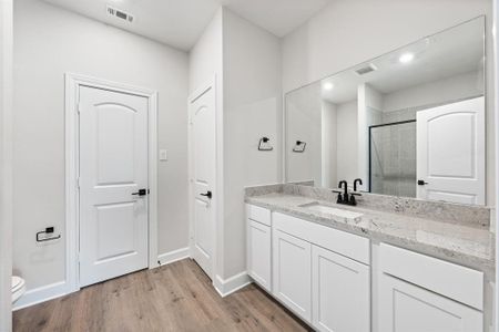 Master bathroom featuring linen closet and separate shower.