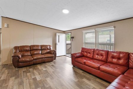 This Living Room provides a sense of relaxation and connection, with abundant natural light streaming through the windows.