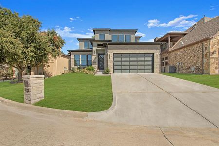 Contemporary home with a front yard, cooling unit, and a garage