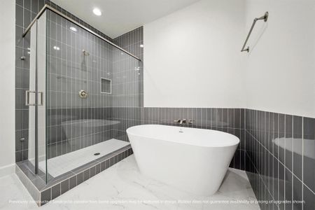 Indulge in the luxurious primary bathroom with a spacious soaking tub and a shower complete with a handy shampoo nook.