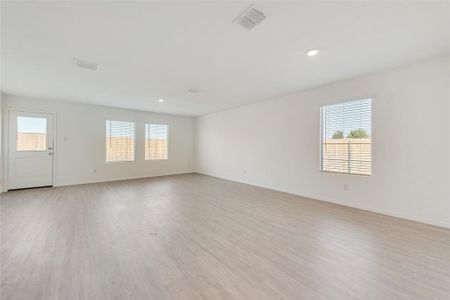 Unfurnished room featuring light hardwood / wood-style flooring and a healthy amount of sunlight