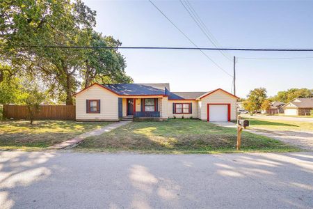 Ranch-style home with a front lawn and a garage