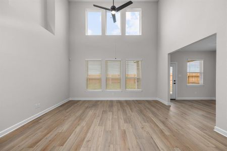 The spacious family room features floor to ceiling windows providing plenty of natural light.