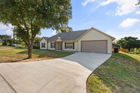 Ranch-style home with a garage and a front lawn