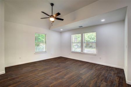 Living room featuring dark hardwood / wood-style floors and ceiling fan