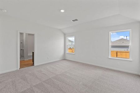 Carpeted bedroom with vaulted ceiling