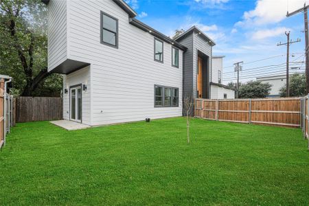 Rear view of house with a lawn