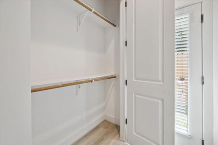A sizable closet offers dual hanging and shelving space with 10ft ceilings for extra storage.