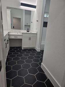 Bathroom featuring a textured ceiling, tile patterned flooring, and vanity