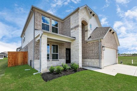 This home boasts lush green grass and meticulous landscaping. Its premium elevation showcases an exquisite blend of brick and stone features, complemented by modern coach lighting
