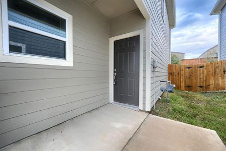 Entrance to property featuring a yard and a patio