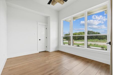 Spare room with ceiling fan and light hardwood / wood-style floors