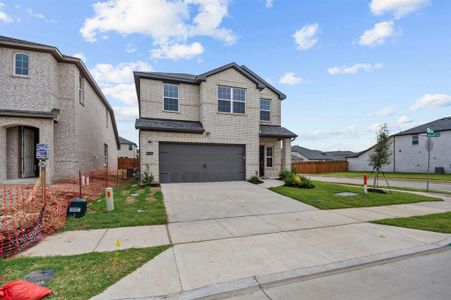 View of front of home featuring a garage and a front yard