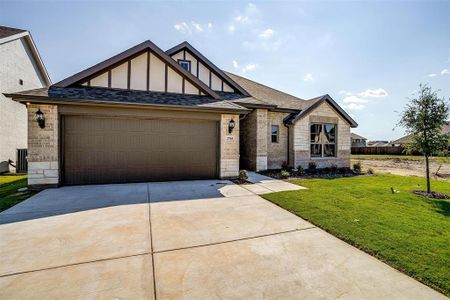 View of front of house featuring cooling unit, a front lawn, and a garage