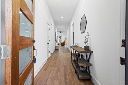 Hall featuring dark wood-type flooring