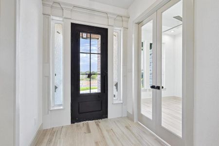 Entryway with light hardwood / wood-style flooring and french doors