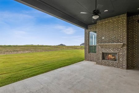 View of patio / terrace featuring an outdoor brick fireplace and ceiling fan