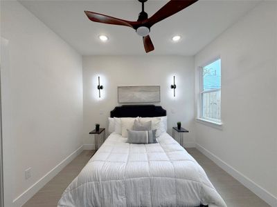 Bedroom featuring hardwood / wood-style floors and ceiling fan