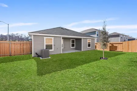 Rear view of property featuring central air condition unit, a yard, and a patio area