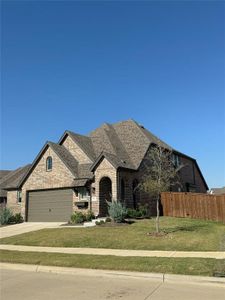 View of front of home with a front lawn and a garage