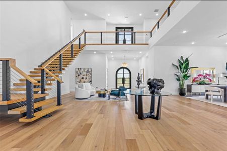 12’ ceilings open up to 24’ expansive open concept living. Floating staircase with 60” white oak treads