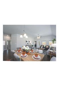 Dining space with ceiling fan with notable chandelier, dark wood-type flooring, and lofted ceiling