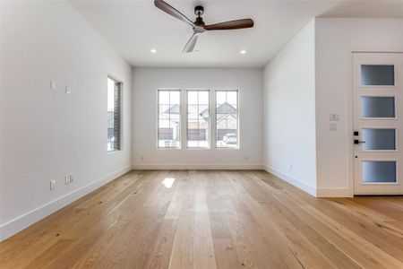 Spare room with light hardwood / wood-style floors and ceiling fan