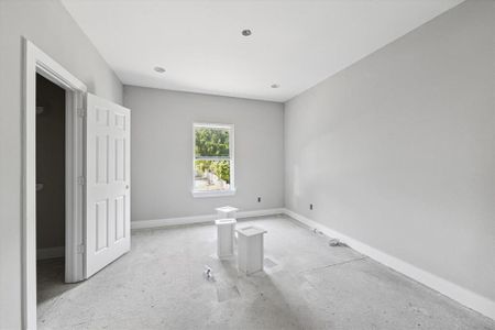 The primary bedroom, the first bedroom located off the landing of the second floor, is situated at the front of the home and overlooks the driveway.