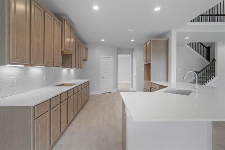 This kitchen is by far any chef’s dream! This spacious kitchen features high ceilings, stained wood cabinets, quartz countertops, SS appliances, modern tile backsplash, recessed lighting, extended counter space, extra space for breakfast bar, and a walk-in pantry all overlooking your huge family room.