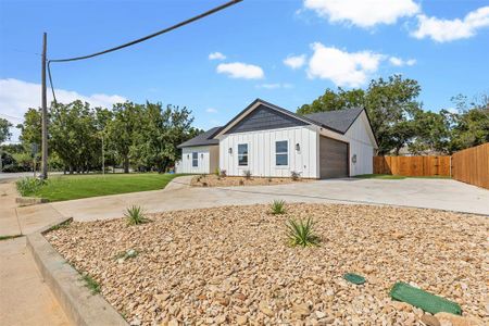 Modern farmhouse with a garage and a front lawn