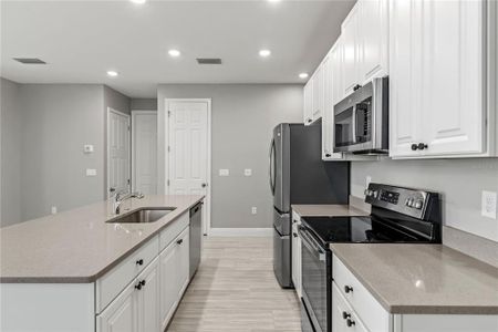 Kitchen with 42" cabinets, quartz countertops and stainless steel appliances