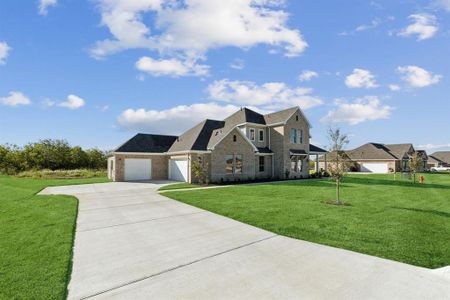 View of front of home with a front lawn and a garage