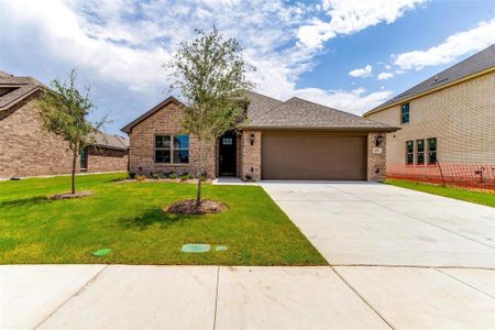 View of front of house featuring a garage and a front yard