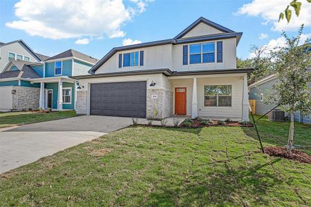 View of front of property featuring a front lawn and a garage