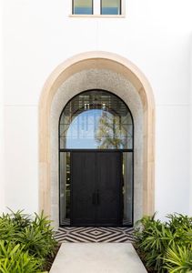 The elegant entrance has a grey Leuter's Limestone arch surround, the same stone is used for stone window sills and crown moldings.