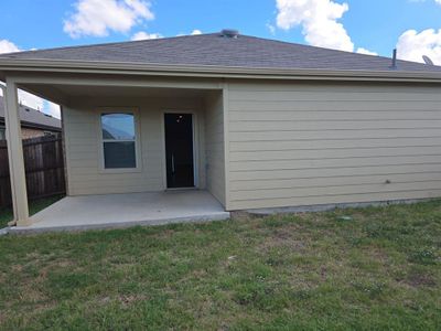 Rear view of house featuring a yard and a patio