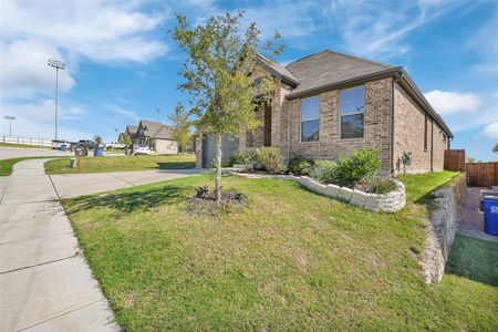 View of front of home featuring a garage and a front lawn