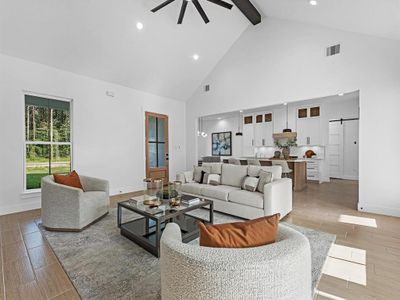 Upon entering you are greeted with a 16ft cathedral ceiling with a tasteful black beam, that runs into a black accent wall showcasing a beautiful electric fireplace. You will also love the over sized windows and tile flooring that run throughout this home.