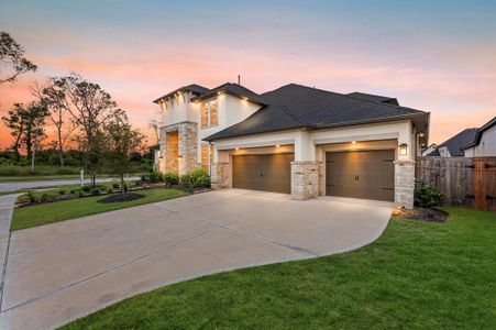 The landscaped front yard, paired with the modern architecture, creates an inviting entryway, hinting at the luxurious interiors within.