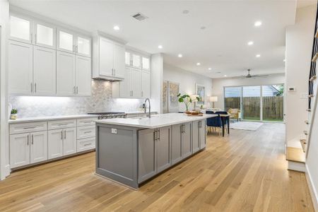 The kitchen features a stunning waterfall quartz island, elegantly designed to comfortably accommodate 4-5 guests.