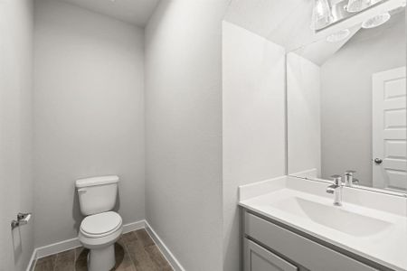 Step into this bright and airy half bath, where a sleek vanity, light counter tops,  and modern hardware elevate the space with contemporary charm. Sample photo of completed home with similar floor plan. As-built interior colors and selections may vary.