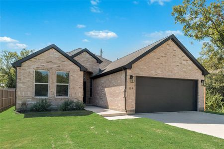 View of front of house with a garage and a front lawn