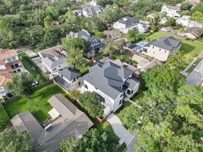 Stunning aerial view showcasing the detached guesthouse, numerous balconies and luscious landscaping. Check out the extra long driveway which allows for additional 2-3 car parking!