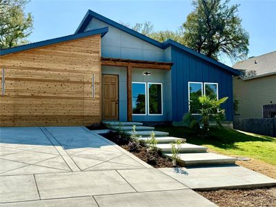 View of front facade featuring a patio area and a front lawn