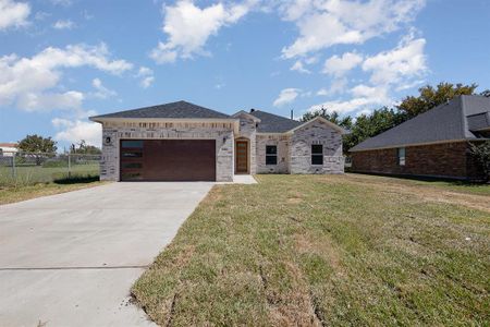 View of front of property featuring a garage and a front lawn