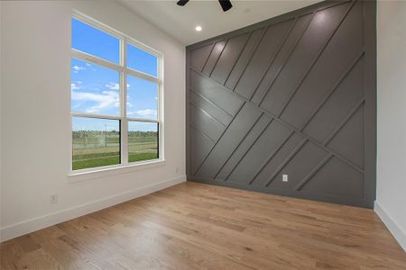 Spare room featuring ceiling fan and light hardwood / wood-style floors