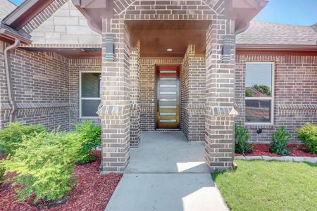 Entrance to property with a lawn