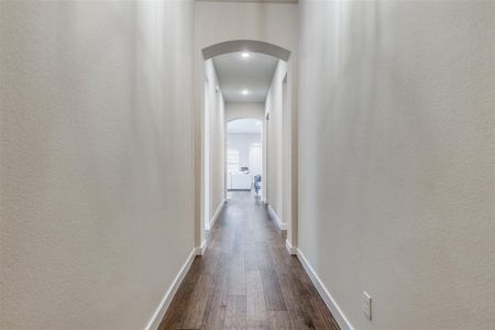 Corridor featuring dark wood-type flooring