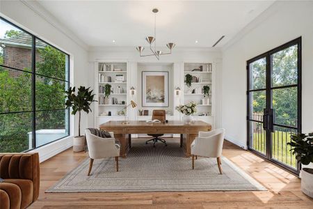 This luxurious study features custom built-in bookshelves and is graced with rich European white oak flooring, creating a warm and inviting atmosphere. French doors flood the space with natural light while offering sweeping views of the lush, expansive back lawn. A perfect blend of elegance and tranquility, this study provides an inspiring space for both work and relaxation. *Virtually staged*