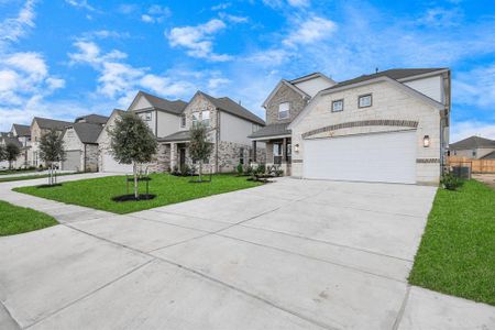 The residence features a practical 2-car garage complemented by a generous driveway, ensuring abundant space for parking needs.